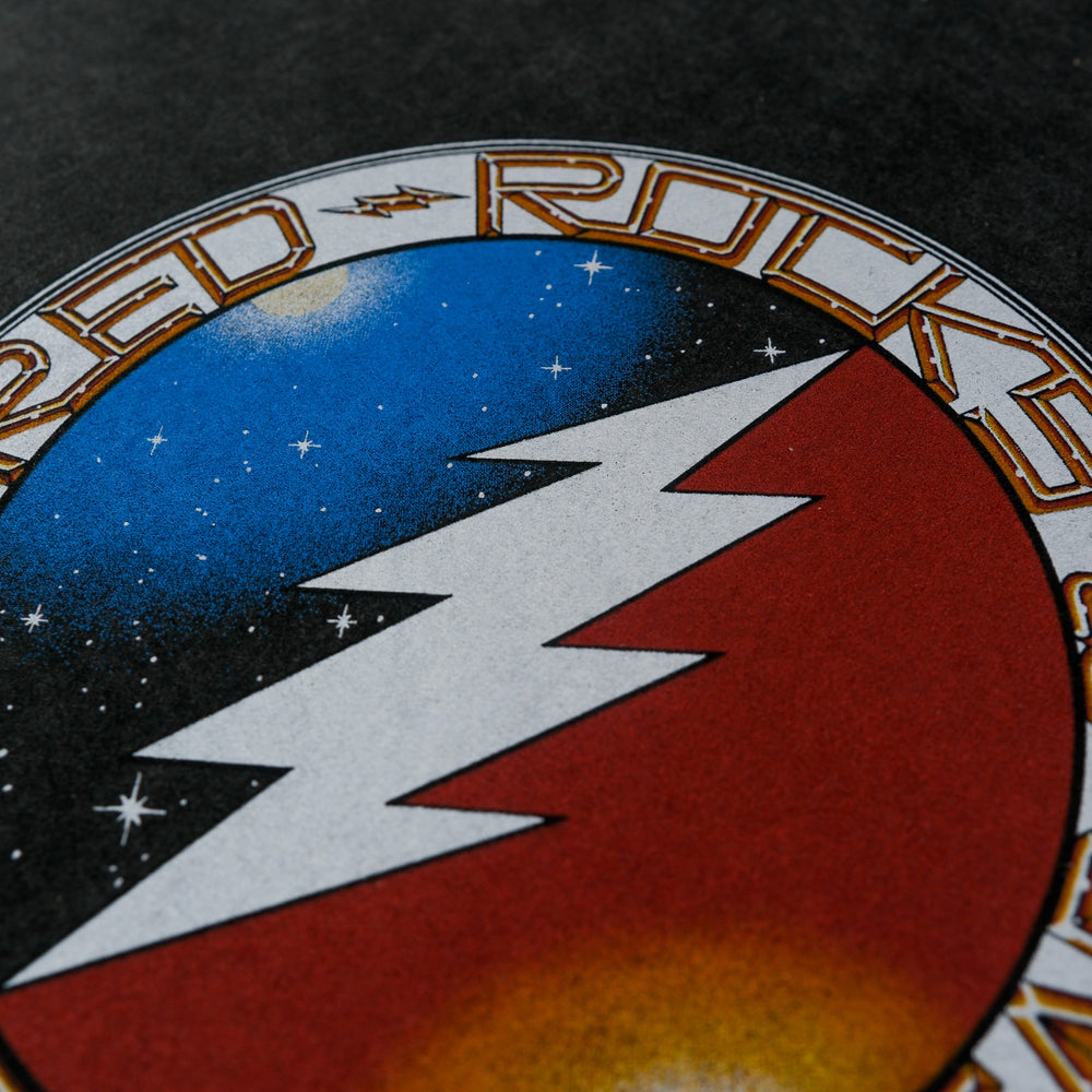 a lighting bot with stars on one side and a sunset on another in a circle grateful dead logo