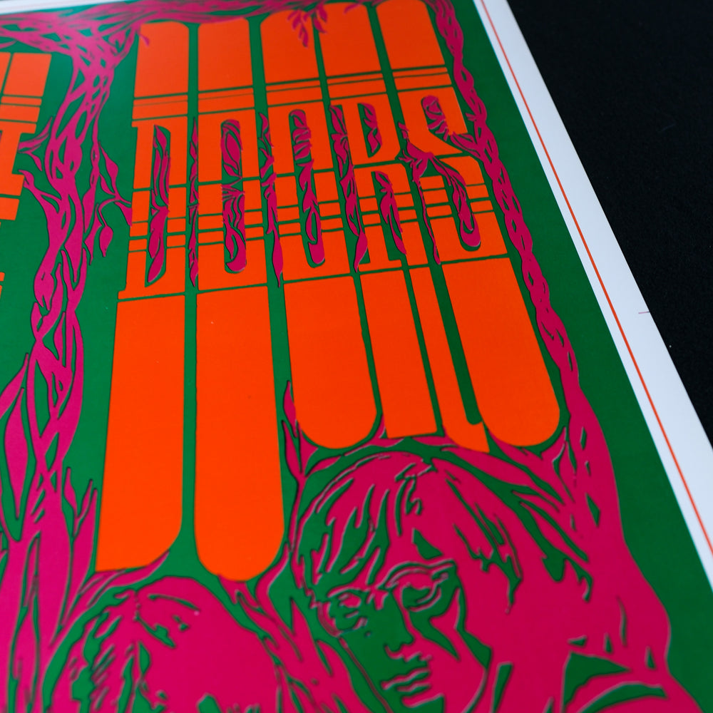 a clsoe up of the doors poster art show ing the name of the band in orange print